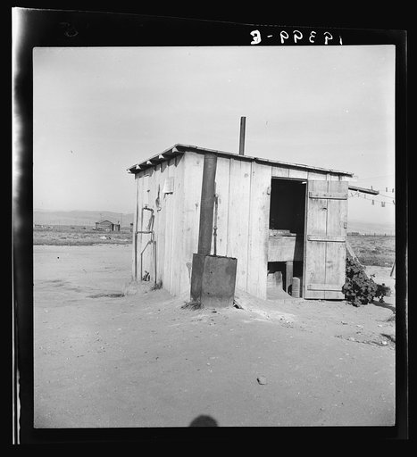 Laundry facilities for ten cabins at Arkansawyers auto camp, Salinas Valley, California. Note stove to heat water