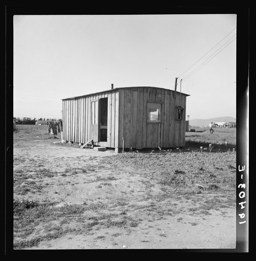 Housing for rapidly growing settlement of lettuce workers on fringe of town, Salinas, California. These houses are built by the occupants, most of them recent migrants from the Southwest