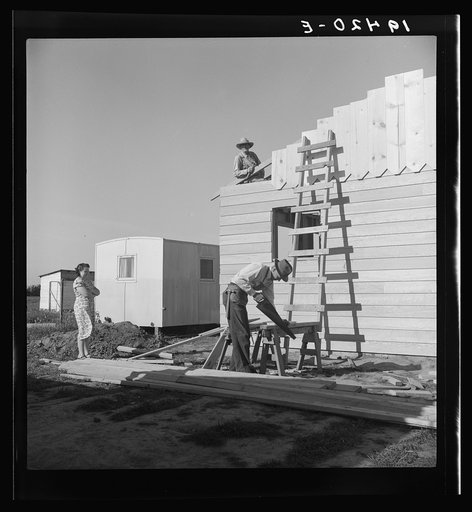 Father and son building house on outskirts of Salinas, California.  Settlement of recently migrated lettuce workers