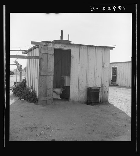 Toilet for ten cabins, men, women, and children. In Arkansawyers auto camp. Greenfield, California