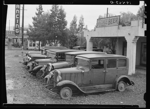 Roadside used car display on State Highway 17, in season when migrants come into region for pea-picking. Santa Clara County, California