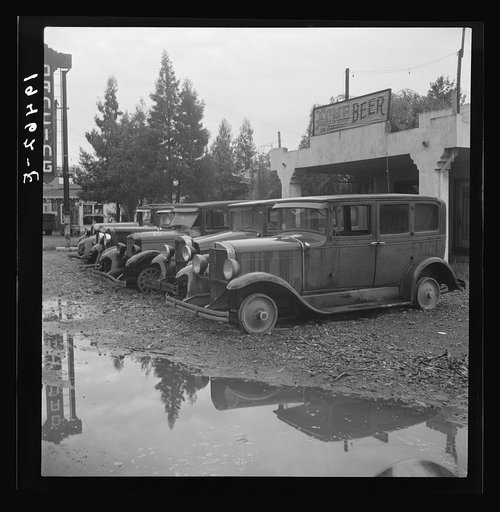 Untitled photo, possibly related to: Roadside used car display on State Highway 17, in season when migrants come into region for pea-picking. Santa Clara County, California