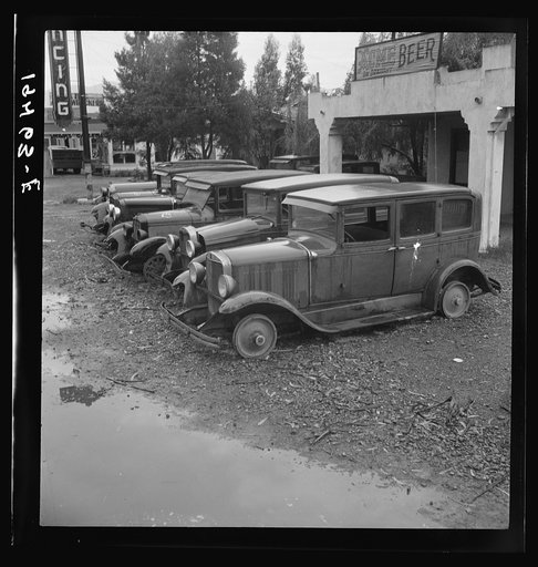 Untitled photo, possibly related to: Roadside used car display on State Highway 17, in season when migrants come into region for pea-picking. Santa Clara County, California