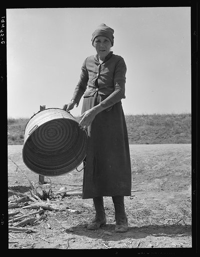 A grandmother in a contractor's camp. Stanislaus County, California. "Been in California fourteen months from Oklahoma. The main thing is to get our families located and quieted down. Ain't no use to send them back; it's a waste of money. They won't stay."