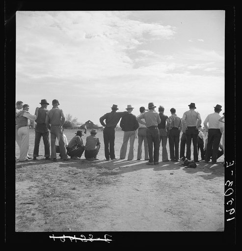 Watching ball game. Shafter camp for migrants. California
