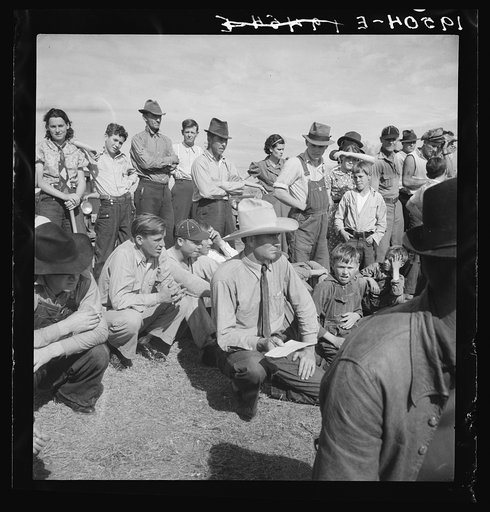 Watching ball game. Shafter camp for migrants. California