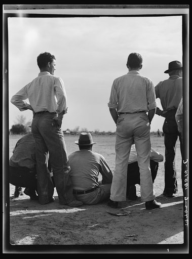 Untitled photo, possibly related to: Watching ball game. Shafter camp for migrants. California