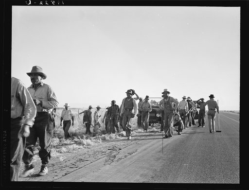 Near Los Banos, California. Migratory agricultural workers. Cotton hoers leave the field at end of the day. Wages twenty cents an hour