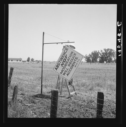 Near Hanford, California. See general caption. On U.S. 99. A member of the committee from adjoining town erects sign on the highway