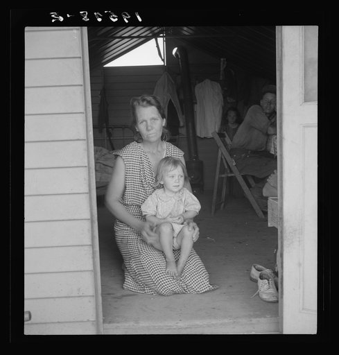 Untitled photo, possibly related to: Tulare County, Farm Security Administration (FSA) camp. Migrant mother and child at doorway of steel shelter