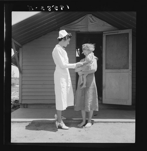 Farm Security Administration (FSA) camp. Farmersville, Tulare County, California. Shows resident nurse come to visit family where there is a sick baby