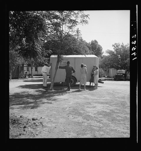 Between Tulare and Fresno on U.S. 99. See general caption. Family inspect a house trailer with idea of purchase