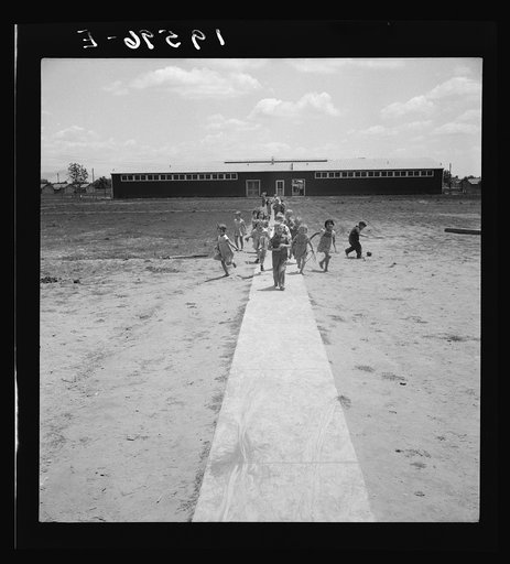 Farm Security Administration (FSA) camp at Farmersville. Nursery school children showing community laundry building. California