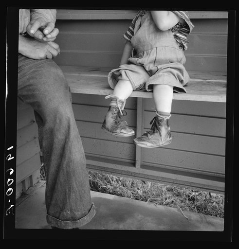 Untitled photo, possibly related to: Tulare County. In Farm Security Administration (FSA) camp for migratory workers. Baby with club feet wearing homemade splints inside shoes