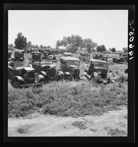 Near Tulare, California, U.S. 99. See general caption. Used car lots and auto wrecking establishments add to the litter which fronts this highway