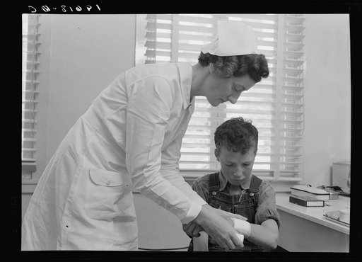 Farm Security Administration (FSA) camp at Farmersville, Tulare County for migratory agricultural workers. Migratory boys come to clinic for attention fo the resident nurse of the Agricultural Workers' Health and Medical Association (FSA)
