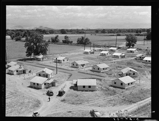 Partially completed homes for agricultural workers to enable them to settle permanently. These houses rent for eight dollars and twenty cents per month which includes water and electricity. This tract adjoins the migratory labor camp. Farmersville, California. Compare 19550 and 19546