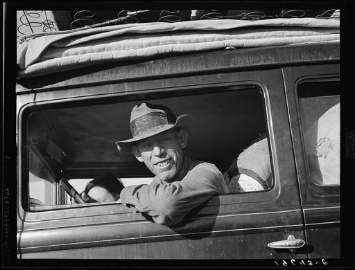 Between Tulare and Fresno on U.S. 99. Farmer from Independence, Kansas, on the road at cotton chipping time. He and his family have been in California for six months