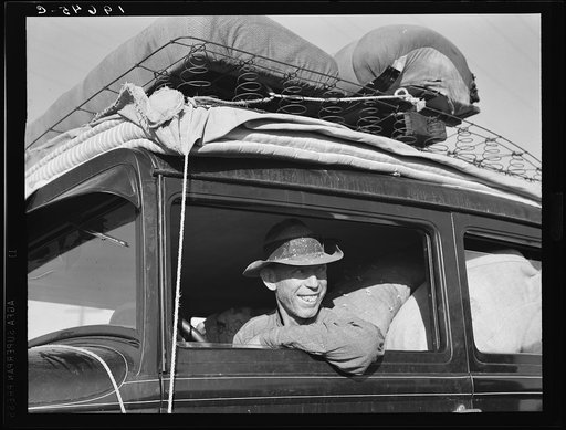 Between Tulare and Fresno on U.S. 99. Farmer from Independence, Kansas, on the road at cotton chopping time. He and his family have been in California for six months