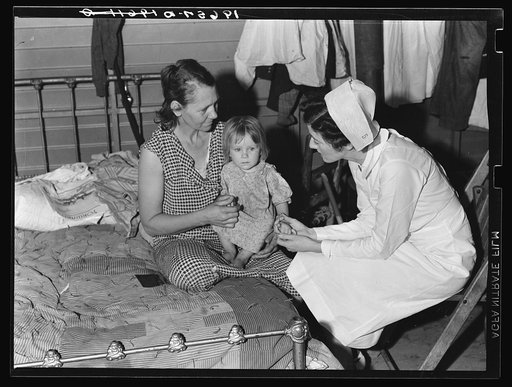 Tulare County, California. Farm Security Administration (FSA) camp for migratory agricultural workers at Farmersville. Nurse of Agricultural Workers' Health and Medical Association (FSA) is assigned to the camp. Photo shows her attending sick baby