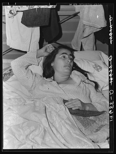 Tulare County, California. Sick woman in Farm Security Administration (FSA) camp for migratory agricultural workers