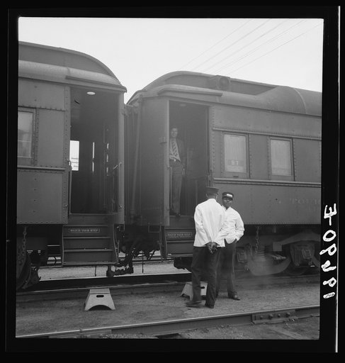 Untitled photo, possibly related to: Railroad yards, Kearney, Nebraska. Overland train passengers go back to their cars after ten minute train stop on trip between San Francisco and Chicago