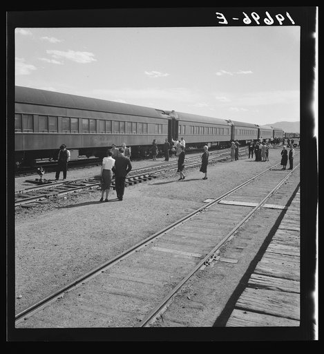 Untitled photo, possibly related to: Railroad yards, Kearney, Nebraska. Overland train passengers go back to their cars after ten minute train stop on trip between San Francisco and Chicago