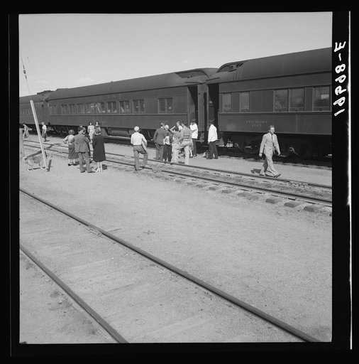 Untitled photo, possibly related to: Railroad yards, Kearney, Nebraska. Overland train passengers go back to their cars after ten minute train stop on trip between San Francisco and Chicago