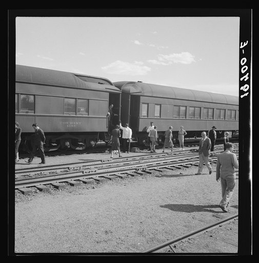 Untitled photo, possibly related to: Railroad yards, Kearney, Nebraska. Overland train passengers go back to their cars after ten minute train stop on trip between San Francisco and Chicago