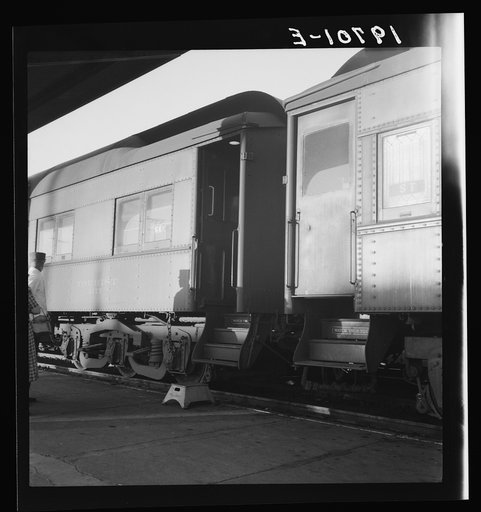 Untitled photo, possibly related to: Railroad yards, Kearney, Nebraska. Overland train passengers go back to their cars after ten minute train stop on trip between San Francisco and Chicago