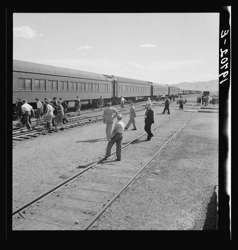 Railroad yards, Kearney, Nebraska. Overland train passengers go back to their cars after ten minute train stop on trip between San Francisco and Chicago