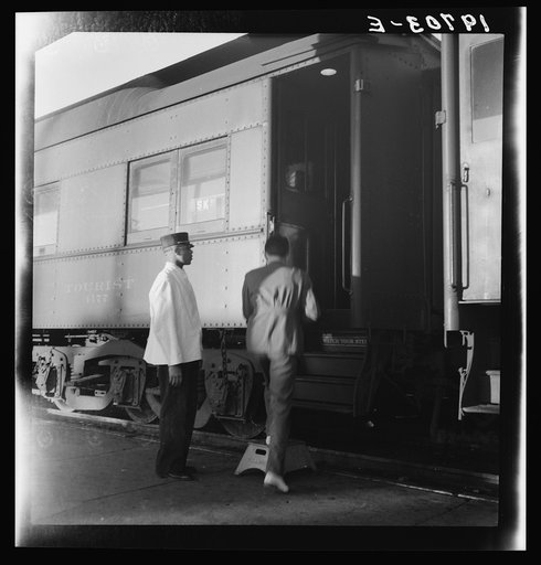 Untitled photo, possibly related to: Railroad yards, Kearney, Nebraska. Overland train passengers go back to their cars after ten minute train stop on trip between San Francisco and Chicago