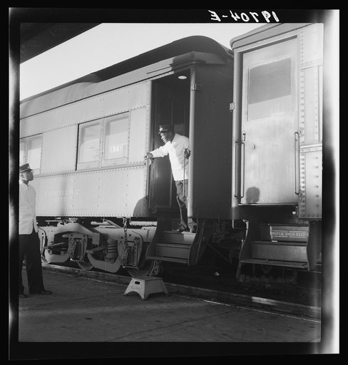 Untitled photo, possibly related to: Railroad yards, Kearney, Nebraska. Overland train passengers go back to their cars after ten minute train stop on trip between San Francisco and Chicago