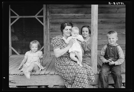 Untitled photo, possibly related to: Wife and children of tobacco sharecropper on front porch. Person County, North Carolina