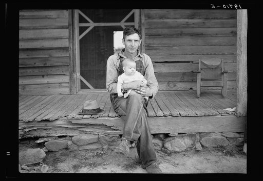 Untitled photo, possibly related to: Mr. Whitfield, tobacco sharecropper, with baby on front porch. North Carolina, Person County