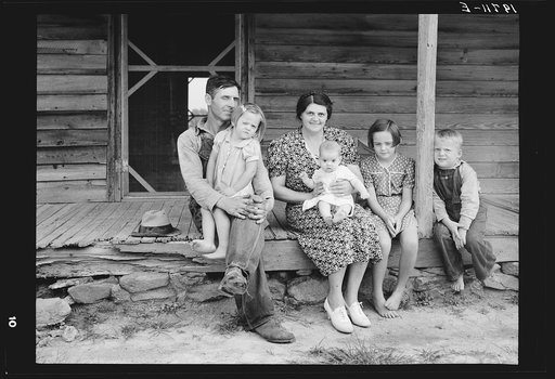 Untitled photo, possibly related to: Wife and children of tobacco sharecropper on front porch. Person County, North Carolina