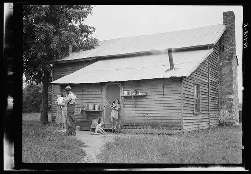 Tobacco sharecropper and his family at the back of their house showing kitchen door, household equipment, foot path to barn. Person County, North Carolina