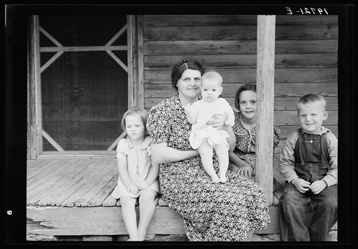 Untitled photo, possibly related to: Wife and children of tobacco sharecropper on front porch. Person County, North Carolina