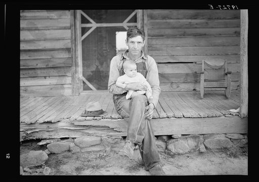 Mr. Whitfield, tobacco sharecropper, with baby on front porch. North Carolina, Person County
