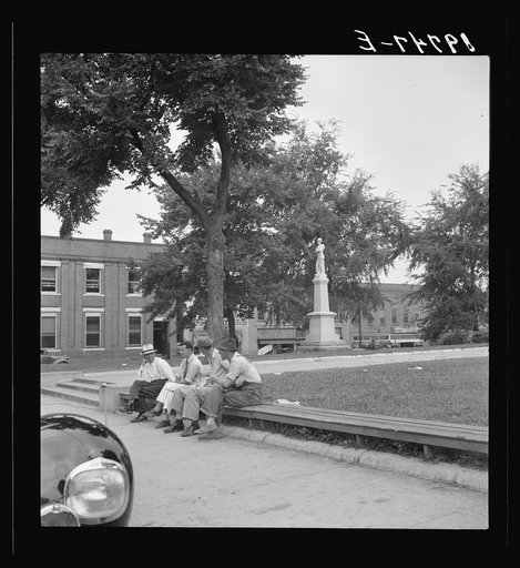 Men idling around the courthouse square. Note Confederate monument characteristic of Southern towns. Roxboro, North Carolina