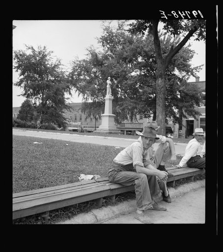 Untitled photo, possibly related to: Men idling around the courthouse square. Note Confederate monument characteristic of Southern towns. Roxboro, North Carolina
