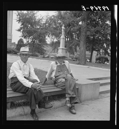 Person County. Farmer in town idling around the county courthouse. Note Confederate monument characteristic of Southern towns. Roxboro, North Carolina