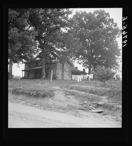 Untitled photo, possibly related to: The one-and-a-half story part of this house was built fifty to sixty years ago. The two-story part was built in 1900. Farm is owned by a woman whose husband died seventeen years ago. Person County, North Carolina