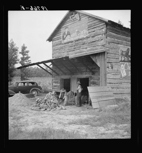 Untitled photo, possibly related to: Putting in new flues in tobacco barn. The fire burns out the bricks and furnaces have to be replaced every ten or fifteen years. Orange County, North Carolina