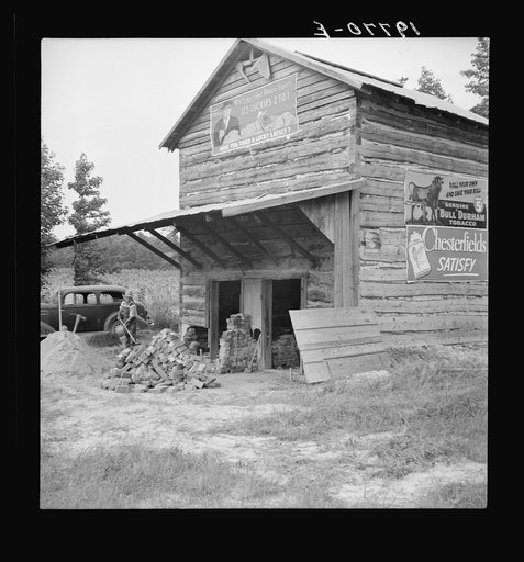 Untitled photo, possibly related to: Putting in new flues in tobacco barn. The fire burns out the bricks and furnaces have to be replaced every ten or fifteen years. Orange County, North Carolina