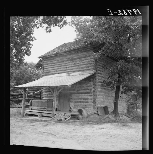 Untitled photo, possibly related to: Tobacco barn with tobacco sled and vehicle used for conveying tobacco sleds. Person County, North Carolina