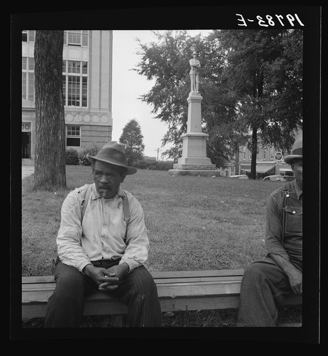 Untitled photo, possibly related to: Men idling around the courthouse square. Note Confederate monument characteristic of Southern towns. Roxboro, North Carolina