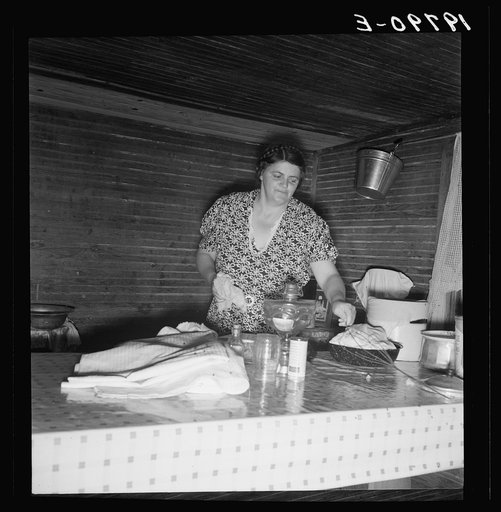 Tobacco sharecropper's wife cleaning up table after washing breakfast dishes. Person County, North Carolina