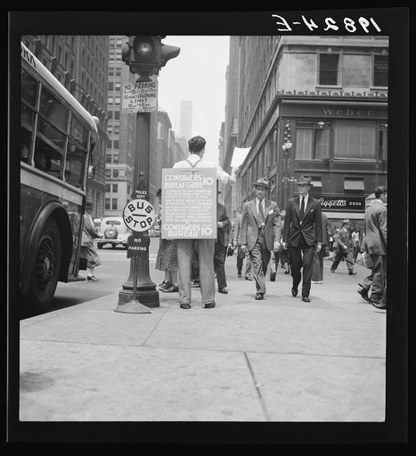 Untitled photo, possibly related to: 42nd Street and Madison Avenue. Street hawker selling Consumer's Bureau Guide. New York City