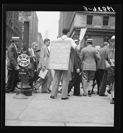 42nd Street and Madison Avenue. Street hawker selling Consumer's Bureau Guide. New York City